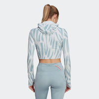 Adidas hooded crop top with zebra print and light blue leggings. Rear view.