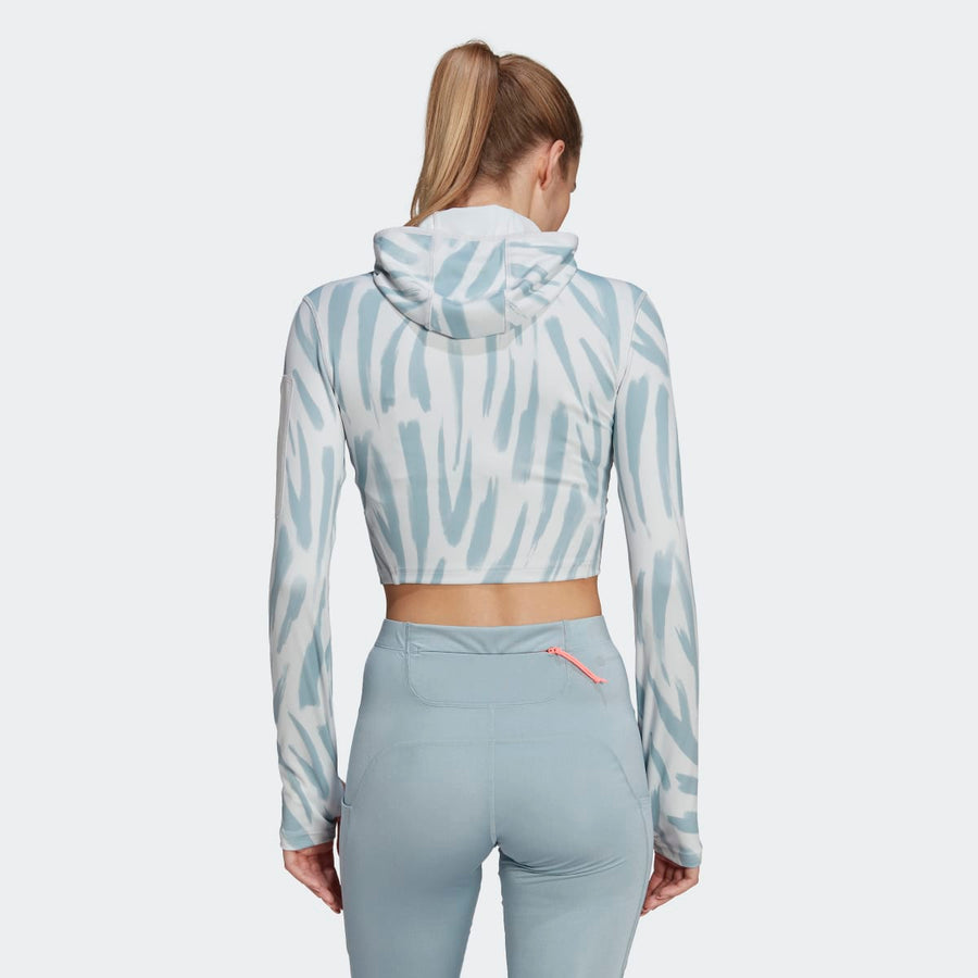 Adidas hooded crop top with zebra print and light blue leggings. Rear view.