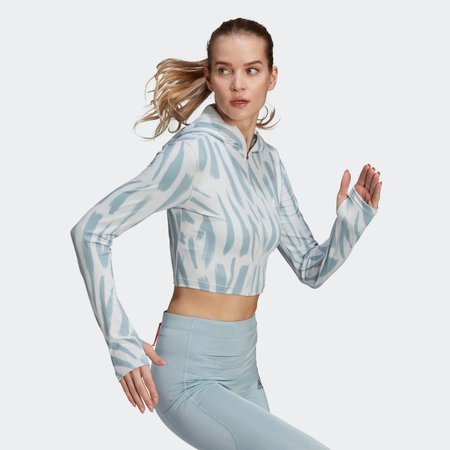 Adidas cropped running hoodie with blue and white print, paired with light blue leggings.